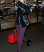 hailey-baldwin-lax-airport-purple-pants-boots-black-leather-jacket-0.jpg