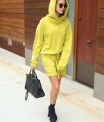 hailey-baldwin-arrives-for-a-meeting-in-new-york-city-yellow-outfit-hoodie-black-ankle-boots-0.jpg