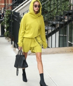 hailey-baldwin-arrives-for-a-meeting-in-new-york-city-yellow-outfit-hoodie-black-ankle-boots-2.jpg