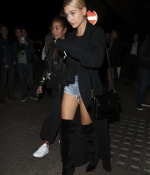 hailey-baldwin-arriving-at-sexy-fish-restaurant-in-london-black-outfit-denim-shorts-jeans-high-leather-boots-6.jpg