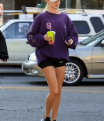 hailey-bieber-november-25-Picks-Up-a-Healthy-Smoothie-in-west-Hollywood-purple-sweatshirt-nike-black-shorts-legs-11.jpg
