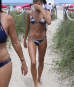 hailey-baldwin-June-11-In-Bikini-on-the-Beach-in-Miami-camo-black-legs-sea-wet-0.jpg