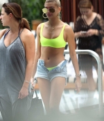 hailey-baldwin-June-9-In-Bikini-Top-and-Denim-Shorts-at-a-Pool-in-Miami-neon-green-pink-top-denim-shorts-5.jpg
