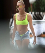 hailey-baldwin-June-9-In-Bikini-Top-and-Denim-Shorts-at-a-Pool-in-Miami-neon-green-pink-top-denim-shorts-7.jpg