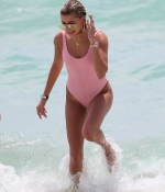 hailey-baldwin-June-10-In-Swimsuit-on-the-Beach-in-Miami-pink-swimswuit-0.jpg